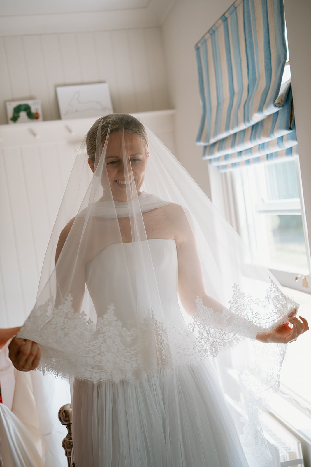 bride with her Emma Beaumont bridal gown and veil before her ceremony