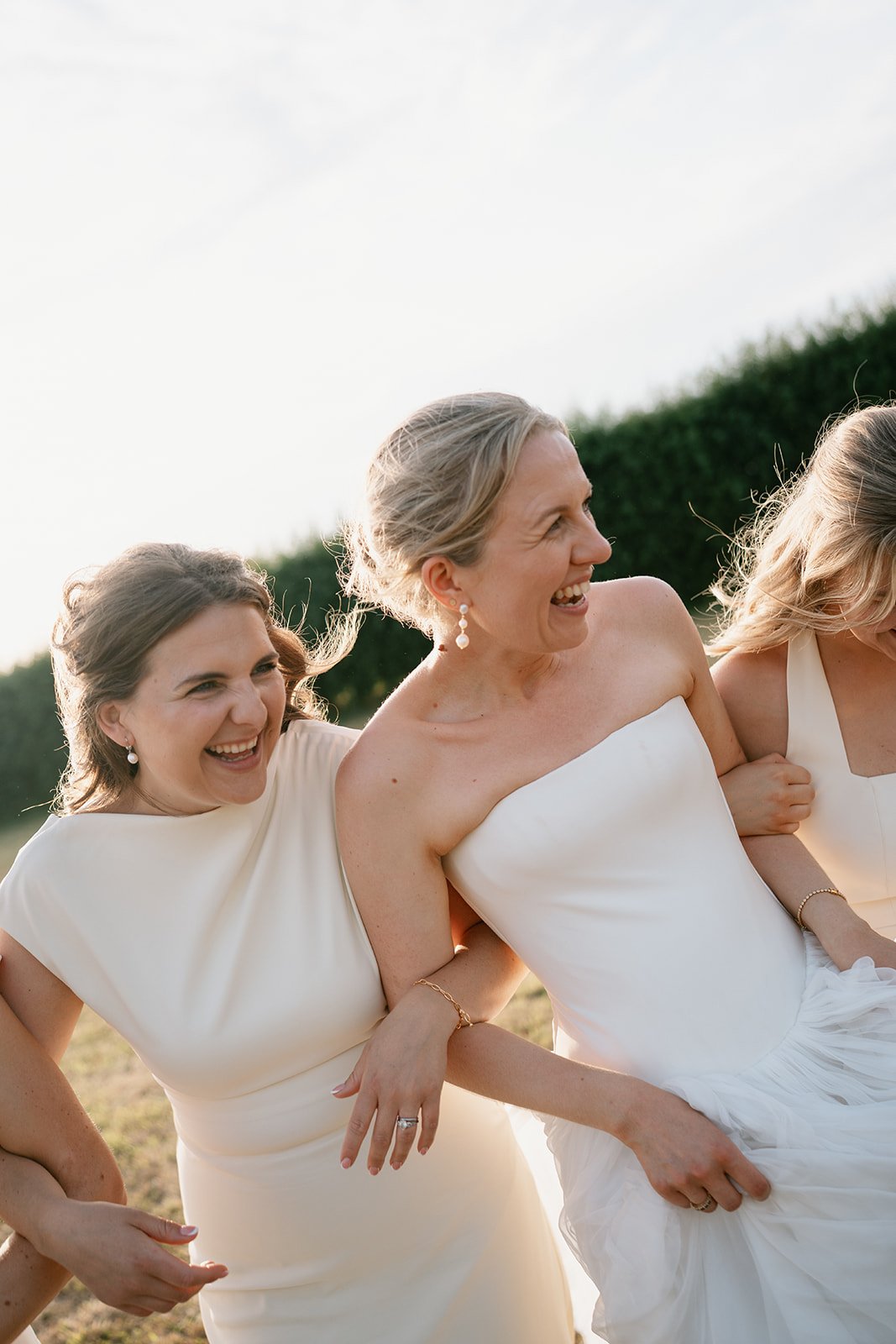 bride and bridesmaids having fun, relaxed bridal portraits on wedding day, coordinated by Hardesty Event Design