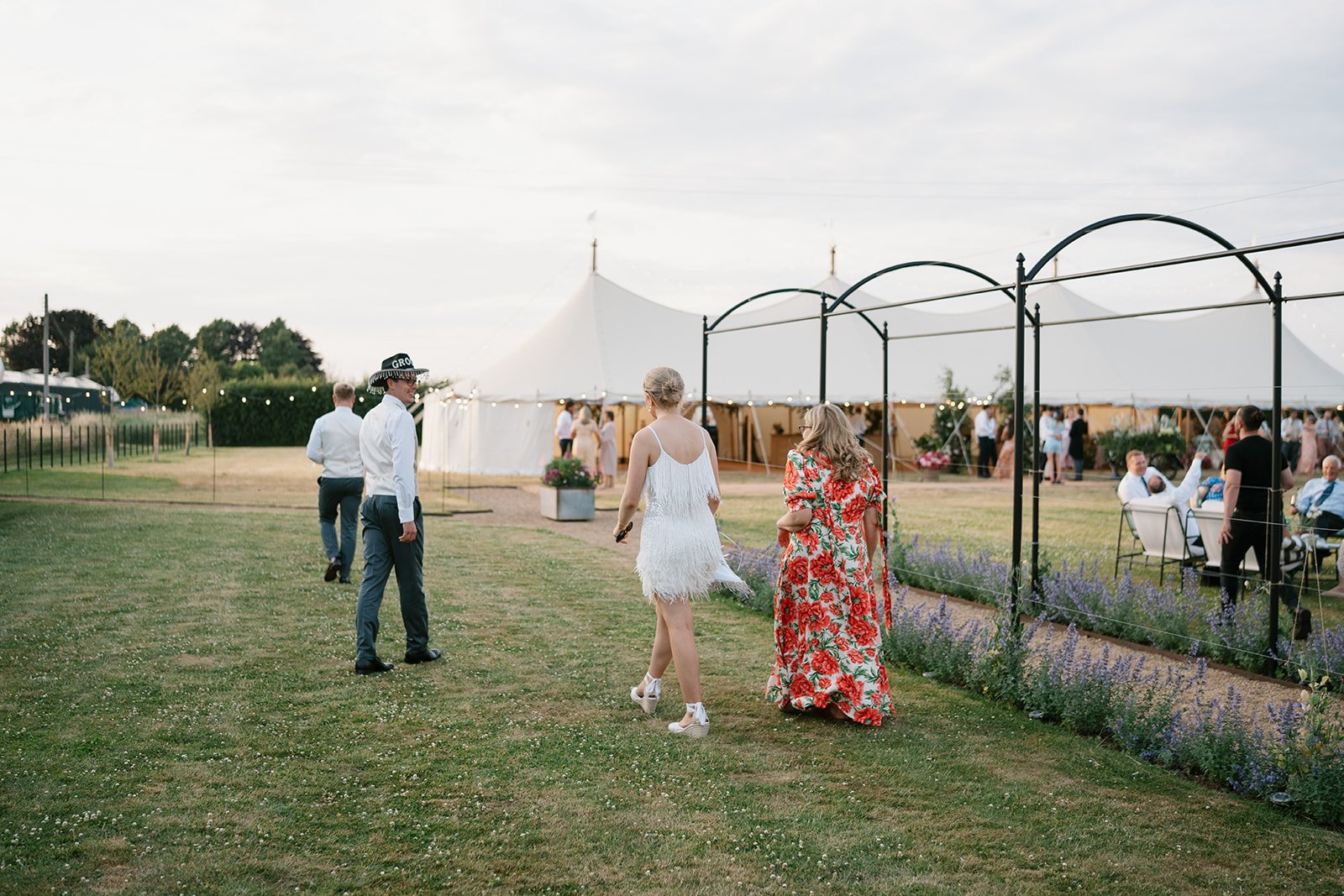 bride and groom captured on wedding day at their at-home marquee reception in the summer sunshine in South Lincolnshire, planned by UK wedding planner